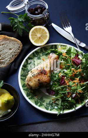 Baked chicken drumsticks with salad. Directly above. Stock Photo