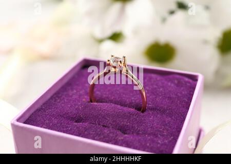 Box with beautiful golden engagement ring, closeup Stock Photo