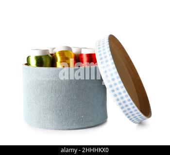 Box with different sewing thread spools on white background Stock Photo
