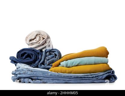 Stack of different female jeans and sweaters on white background Stock Photo