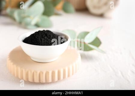 Bowl with activated charcoal tooth powder on white background Stock Photo