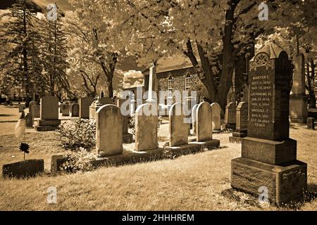 A very old cemetery in an 1776 English Reform Church yard. This infrared,abstract, sepia photo is a scary and a good look for Halloween. Stock Photo