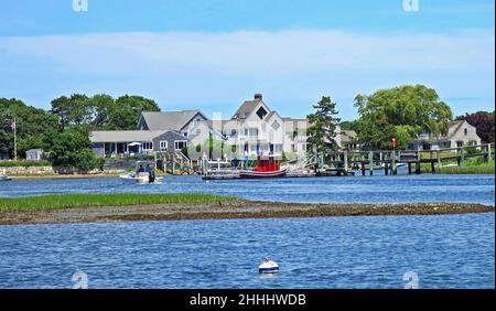 Lewis Bay inlet in Cape Cod,Massachusetts.USA, with Red Tugboat and clear blue skies. Near Hyannis Harbor. Stock Photo
