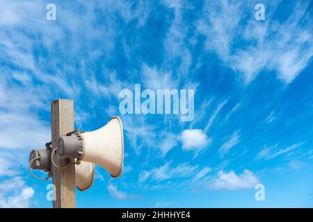 Megaphone against blue sky with copy space. Stock Photo