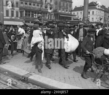 Refugees from the advancing German Army seen here  in Brussels. Orphaned by war. The big sister has now a great responsibility, for she must act as mother to these young children. Circa 19th August 1914 Stock Photo