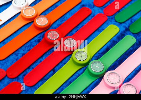 Row of multicolored clocks on display Stock Photo