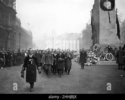 Soldiers active and de-mobbed march pass the cenotaph in Whitehall on the first anniversary of Armistice Day. 11th November 1919 Stock Photo