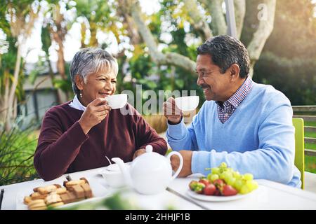 Retirement done right. Shot of a happy older couple having tea together outdoors. Stock Photo