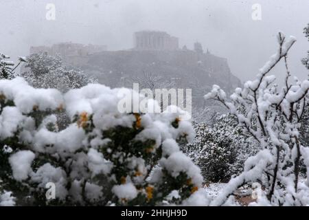 Athens, Greece. 24th Jan, 2022. The Acropolis is seen in the snow in Athens, Greece, on Jan. 24, 2022. An intense cold front was sweeping through Greece on Monday, causing travel disruptions and power outages for several hours in many regions, the local authorities said. Credit: Marios Lolos/Xinhua/Alamy Live News Stock Photo
