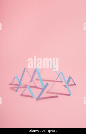 Creative abstract geometric Zig Zags lines arranged in chart pattern placed on pink background with shadow in light modern studio Stock Photo