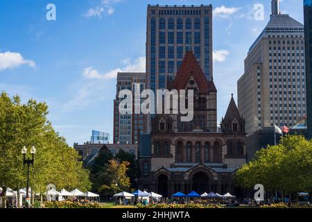 Boston, USA - October 22, 2021: Farmers market at Copley Square on a sunny day. Trinity Church and modern tall buildings in the background Stock Photo