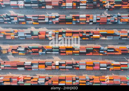 Full frame of drone view of multicolored cargo containers arranged in parallel lines on ship dock Stock Photo