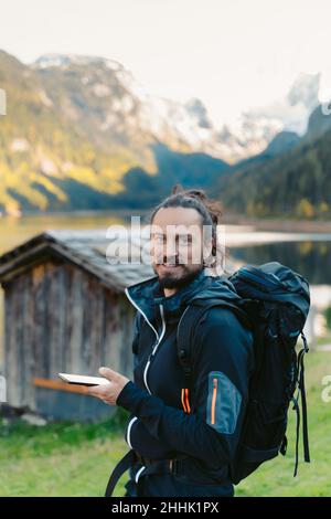 Calm concentrated young female standing in Tree pose with namaste hands while practicing mindfulness and meditation during yoga class in fitness studi Stock Photo