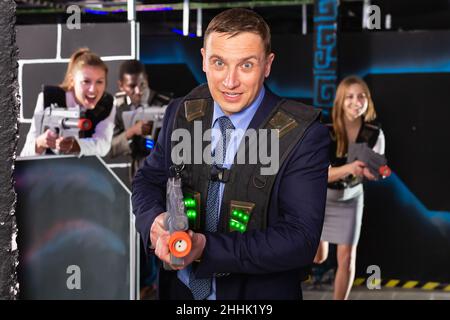 Man holding laser gun and playing laser tag Stock Photo - Alamy