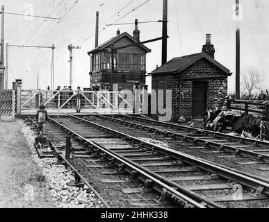 Fatal Crossing Crash. The driver, Mr Fred Adamson, of Darlington, was killed and his two passengers were injured when a sports car was in collision with a train at this level-crossing at Travellers' Rest, Aycliffe, Durham. The wreck of the car can be seen on the right.  16th March 1935. Stock Photo