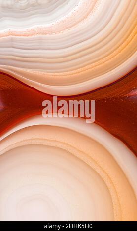 Macro of abstract background of agate gemstone with white and red spots and lines Stock Photo