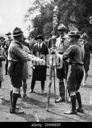 Sir Robert Baden-Powell, founder of the Scouts Youth movement, hands a memento totem pole to a South African delegate at the 3rd World Scout Jamboree, held at Arrowe Park in Upton, Merseyside.The jamboree commemored the 21st birthday of Scouting for Boys and the Scouting movement. 5th August 1929. Stock Photo