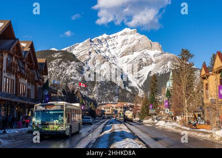 Banff, Alberta, Canada - January 23 2022 : Downtown Banff Avenue in a winter sunny day, during covid-19 pandemic period. Stock Photo