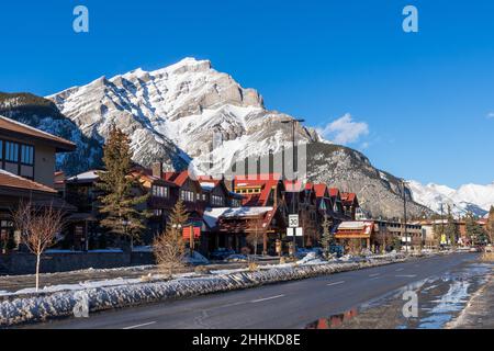 Banff, Alberta, Canada - January 23 2022 : Downtown Banff Avenue in a winter sunny day, during covid-19 pandemic period. Stock Photo