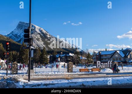Banff, Alberta, Canada - January 23 2022 : Downtown Banff Avenue in a winter sunny day, during covid-19 pandemic period. Stock Photo