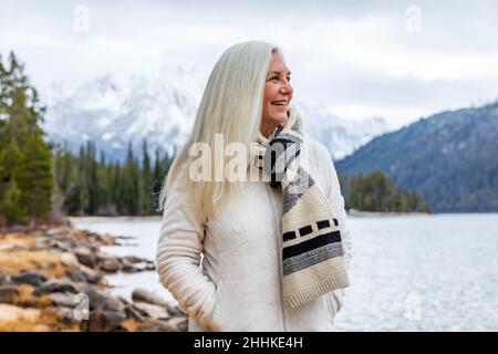 USA, Idaho, Stanley, Smiling senior woman at mountain lake Stock Photo