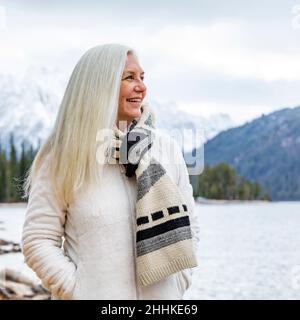 USA, Idaho, Stanley, Smiling senior woman at mountain lake Stock Photo