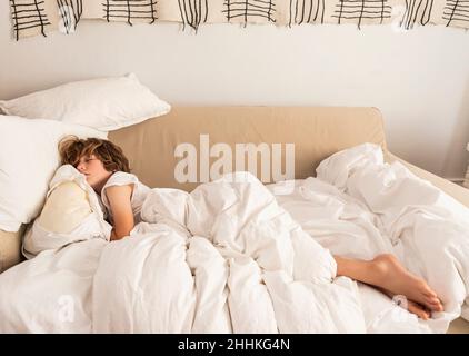 Boy (8-9) sleeping on sofa Stock Photo