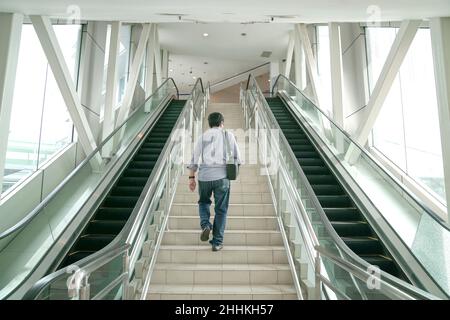 Man going up the stairs inside a subway station. Going back to work or transit concept. Stock Photo