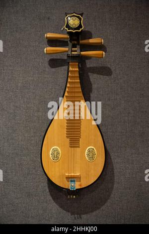 Antique Asian music instrument, pipa, hung in wall in a music