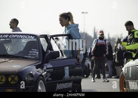 Young girl getting out of her nice classic BMW E30 tuned stance style in Spain Stock Photo