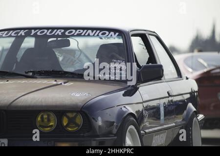 Nice classic BMW E30 tuned stance style with rusty bonnet in Barcelona, Spain Stock Photo