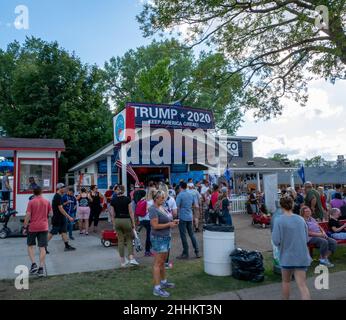 FALCON HEIGHTS, MN - 23 AUG 2019: TRUMP 2020 political booth at the State Fair with crowds of people enoying themselves at the largest annual even in Stock Photo
