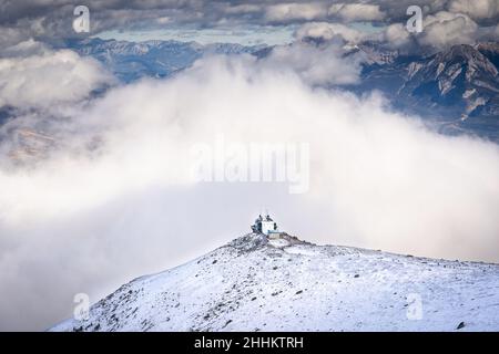 The mountain top gondola tower on Whistlers Mountain surrounded by cloud formations in Jasper National Park Canada. Stock Photo
