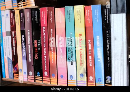 Lampung, Indonesia, January, 25 2022 : Wall of colorful books on library shelf. College textbooks Stock Photo