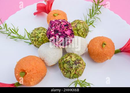 Indian sweet food item colourful and tasty Laddus or Ladoos of three different colours tricolour pistachio,coconut and motichur. Republic day and Inde Stock Photo