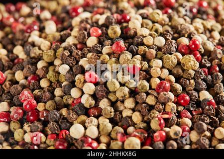 Texture background Multi-colored peppercorns on black plate. Stock Photo