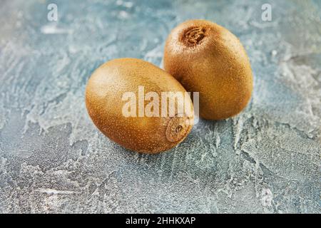 Fresh kiwi on blue background. Background of beautiful homemade kiwi. Stock Photo