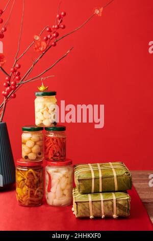 Sticky rice cakes packed in lotus leaves and candiend vegetable prepared for Chinese New Year Stock Photo