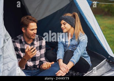 Young nice couple having fun on camping Stock Photo