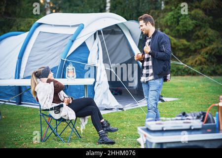Young nice couple having fun on camping Stock Photo