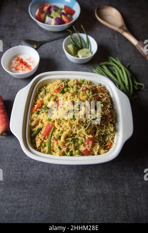 Homemade Indian lunch item pulao or vegetable fried rice or biryani served in a bowl. Close up. Stock Photo