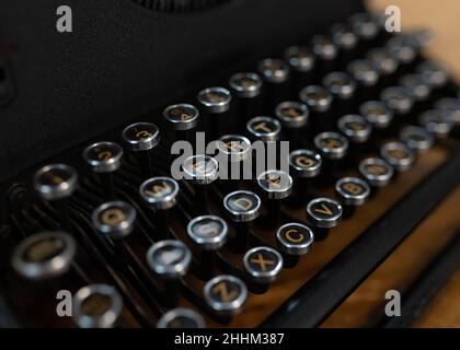 Old fashioned circular round type writer keys, vintage retro industrial style typing machine. Stock Photo