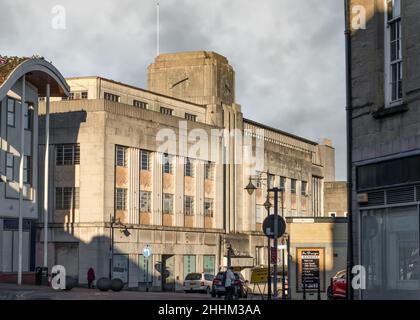 Run down old department store shop closed on city high street in town centre 1950's art deco styling clock tower, boarded up shut down no customers Stock Photo