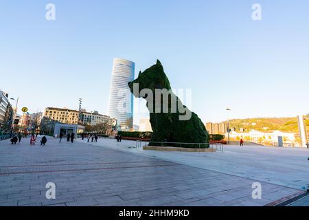 BILBAO, SPAIN-DECEMBER 18, 2021 : Puppy stands guard at Guggenheim Museum in Bilbao, Biscay, Basque Country, Spain. Landmarks. Dog sculpture of artist Stock Photo