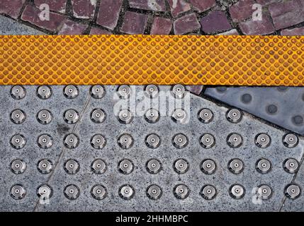 Warning bumps for blind people on sidewalk Stock Photo
