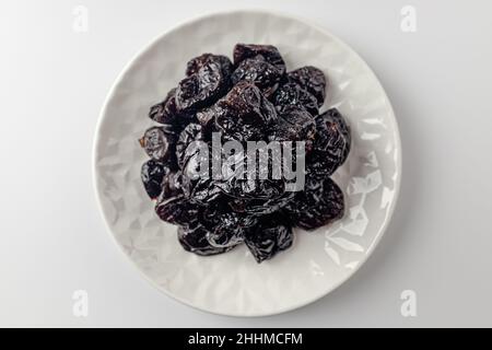 dried plums on a white background Stock Photo