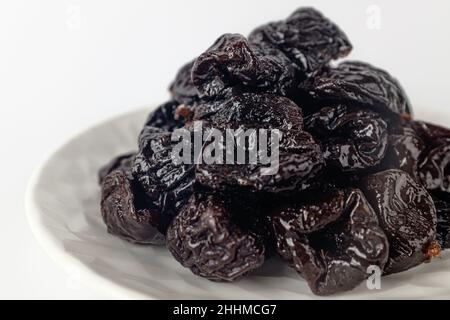 dried plums on a white background Stock Photo
