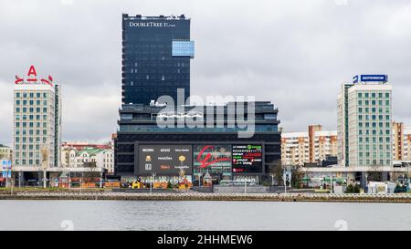 The building of the DoubleTree by Hilton hotel and shopping center in the center of Minsk.  View from the Svisloch river embankment. Stock Photo