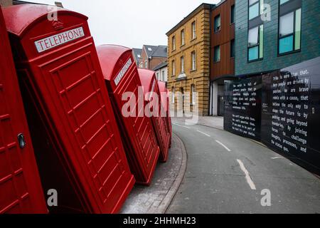 Kingston upon Thames, UK. 24th January, 2022. Out of Order, an artwork by David Mach featuring toppling telephone boxes, was installed on Old London R Stock Photo