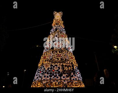 christmas tree with colorful christmas lights on black background Stock Photo